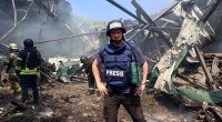 Sun man Paul Sims is pictured at the scene of a bombed-out publishing warehouse