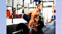 muscular man doing barbell deadlift at the gym