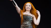 Ice Spice shows off her figure in a skin-tight mini dress in Denmark