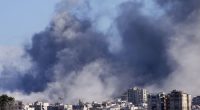 Smoke rises between buildings hit in Israeli airstrikes in Hosh neighbourhood, in Tyre, south Lebanon