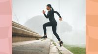 fit, focused woman doing stair runs outdoors on foggy day