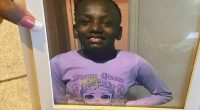 A family member holds up a photo of Shamiya Stewart. (Jan. 27, 2025)
