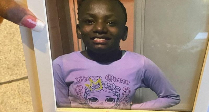 A family member holds up a photo of Shamiya Stewart. (Jan. 27, 2025)