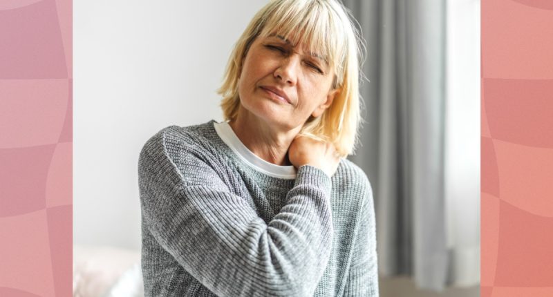 mature blonde woman in gray sweater dealing with joint/neck pain at home