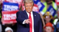 Donald Trump pointing at the camera during a campaign rally.