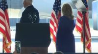 President Biden and Jill Biden at a podium with American flags.