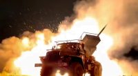 A Russian rocket launcher fires toward Ukrainian position