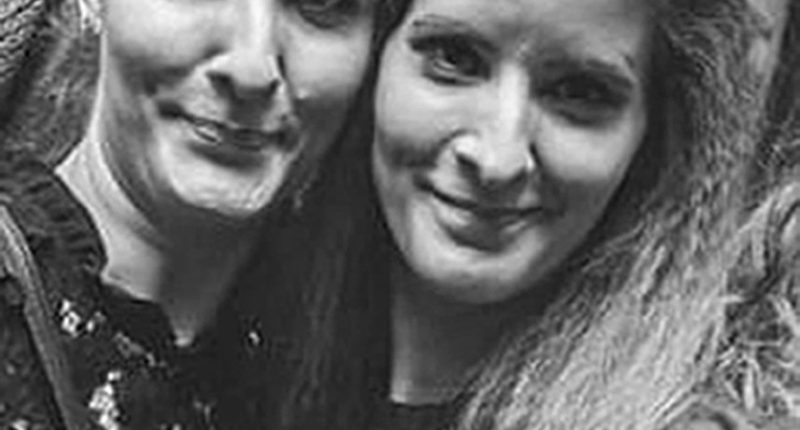 CCTV image of two sisters walking down a street at night.