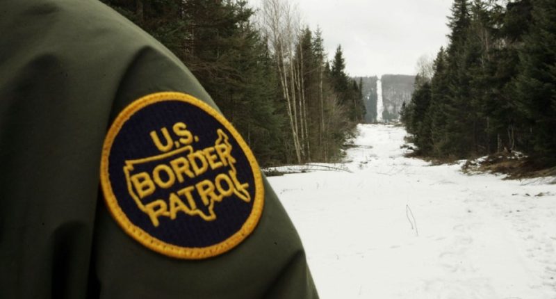 U.S. Border Patrol agent's uniform patch and snowy border landscape.
