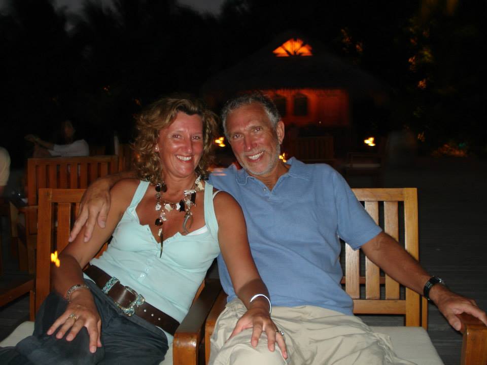 A couple sitting together outdoors at night.