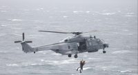 French helicopter performing a sea rescue.