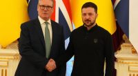 Keir Starmer and Volodymyr Zelenskyy shaking hands.