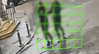 Blurry image of a person walking in a puddle.
