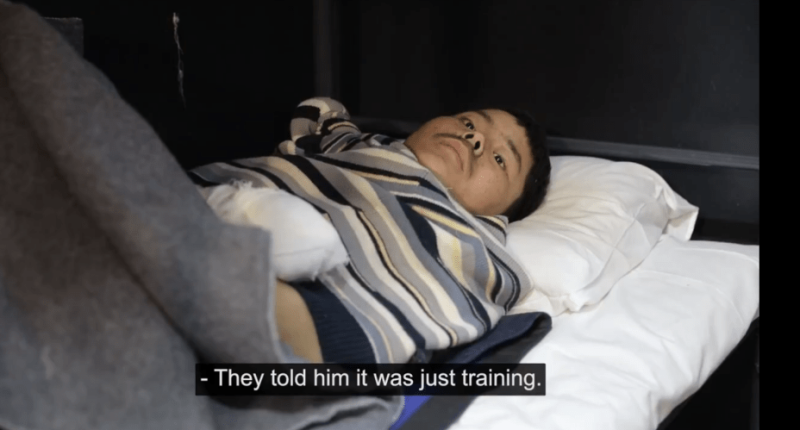 Man lying in bed with bandaged arm.