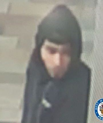 Low-quality CCTV image of a hooded suspect.