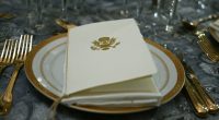 Place setting with the presidential seal on a menu.