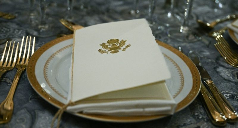 Place setting with the presidential seal on a menu.