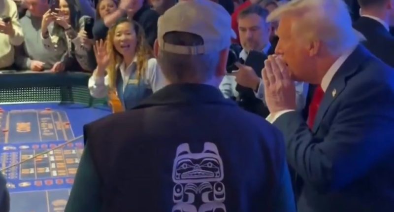Donald Trump at a craps table in a casino, interacting with players and onlookers.