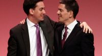 David Miliband and Ed Miliband embracing at a Labour party conference.
