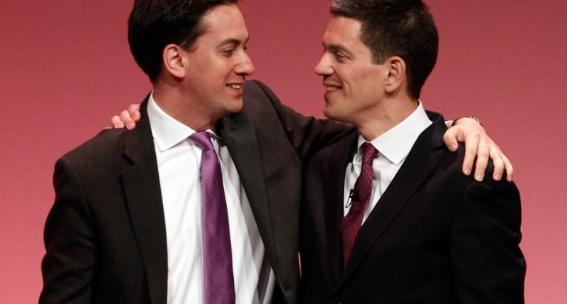 David Miliband and Ed Miliband embracing at a Labour party conference.