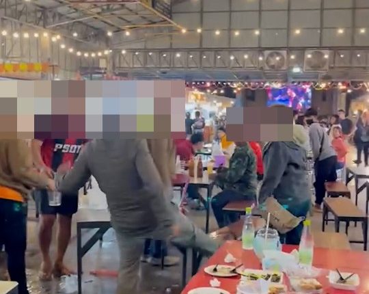 A fight breaks out at a crowded market in Surin, Thailand.