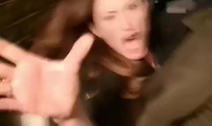 A woman yelling and gesturing wildly.