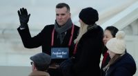 A stand-in for Donald Trump pretends to take the oath of office alongside a fake Melania
