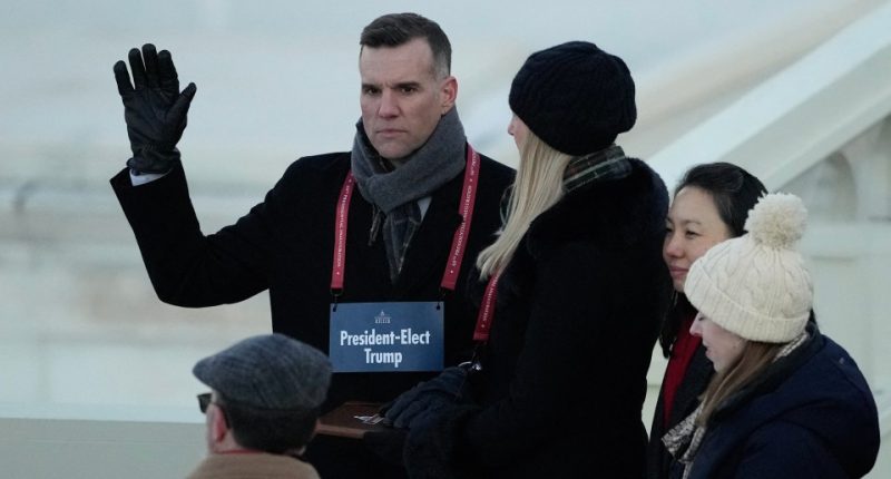 A stand-in for Donald Trump pretends to take the oath of office alongside a fake Melania