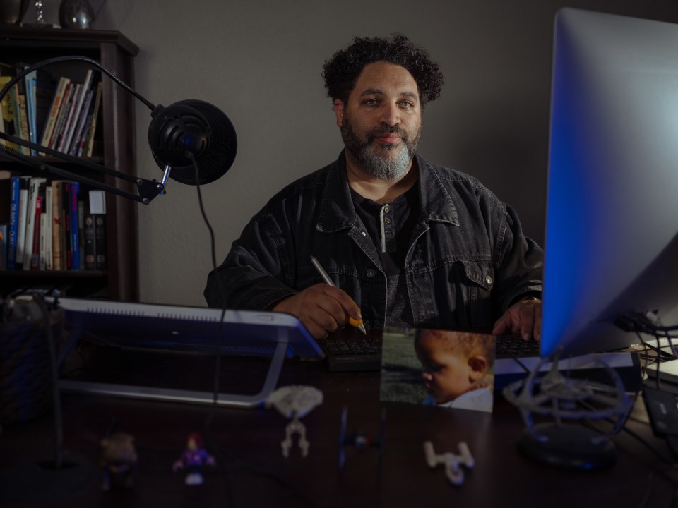 Pulitzer Prize-winning editorial cartoonist Darrin Bell at his desk.