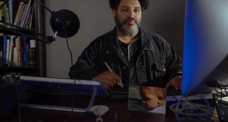 Pulitzer Prize-winning editorial cartoonist Darrin Bell at his desk.