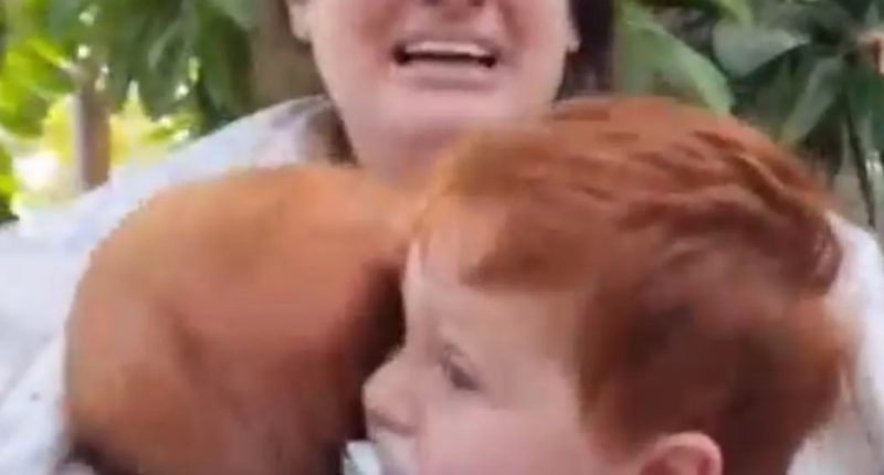 Screengrab of a mother holding her two young sons, hostages of the Hamas attack in Israel.