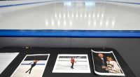 Photos of figure skaters Jinna Han, Spencer Lane, and coaches Vadim Naumov and Evgenia Shishkova displayed at an ice rink.