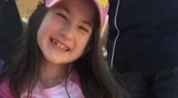Photo of a young girl smiling and winking.