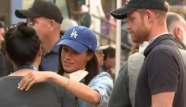 Prince Harry and Meghan Markle comforting a volunteer at a food distribution event.