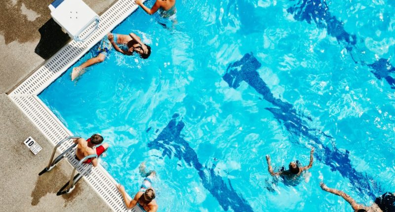 Overhead view of a group of teenagers playing in a swimming pool.