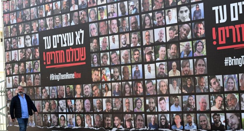 Billboard displaying photos of Israeli hostages with the hashtag #BringThemHomeNow.