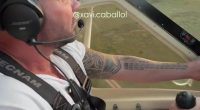 Man piloting an ultralight aircraft.