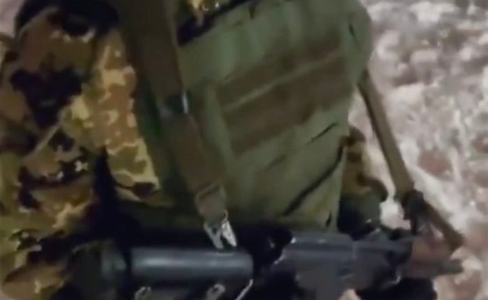 A young child in military uniform holds a rifle.  Text overlay reads, "Learn how to kill Ukrainians. Now you'll practice next."