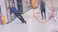 CCTV footage of a man hitting another man in the head with a shovel in a supermarket.