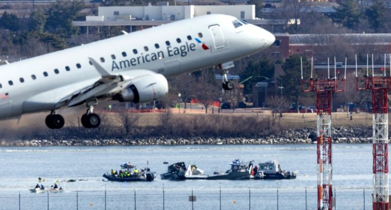 American Eagle plane taking off over water with rescue boats below.