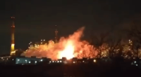 Large fire at an industrial plant at night.