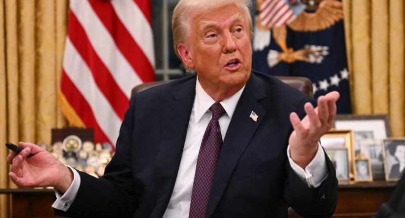 Donald Trump speaking at a table.