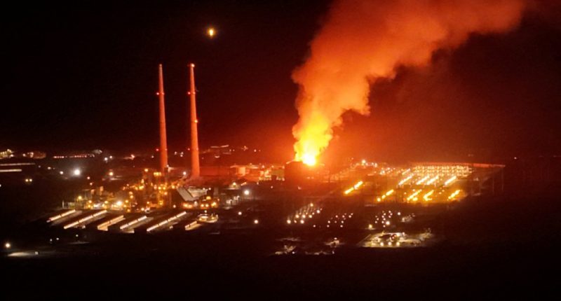 Fire at a power plant at night.