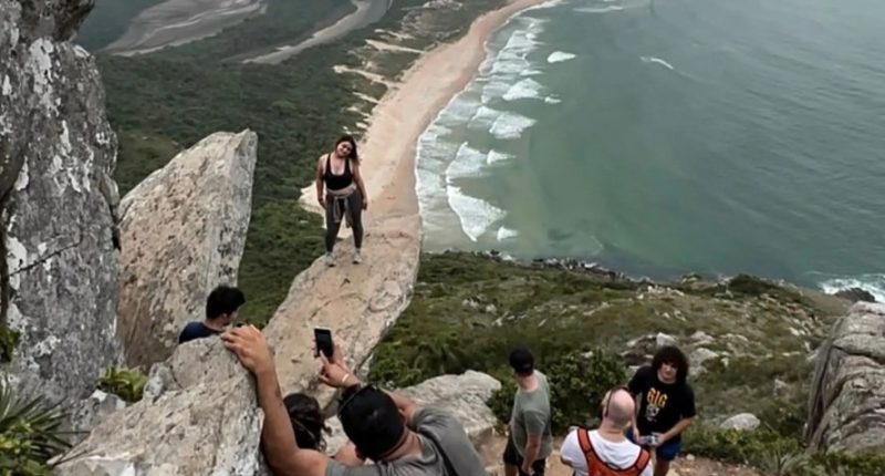 Influencers and tourists are seen at Pedra do Surfista (Surfer's Rock) near Florianopolis, Brazil