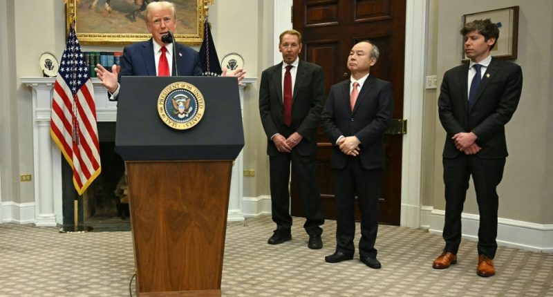 President Trump speaking at a podium with three men standing behind him.