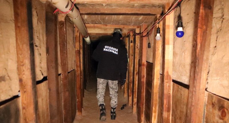 National Guard agent inspecting an illegal tunnel at the US-Mexico border.