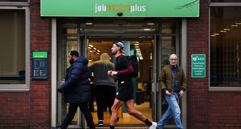 People walking past a Jobcentre Plus in London.