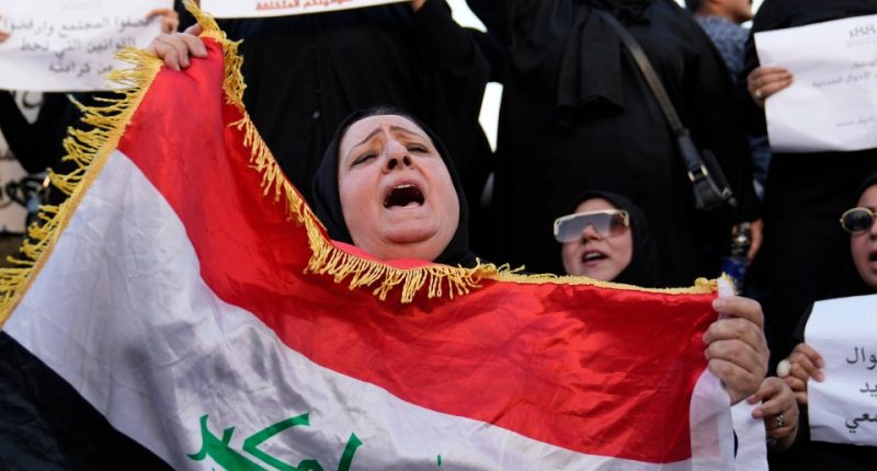 Iraqi woman protesting proposed law allowing underage marriage, holding Iraqi flag.