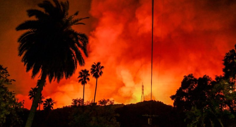 CALIFORNIA, USA - JANUARY 10: A view of wild fire as firefighting planes and helicopters drop water over flames in Mandeville Canyon during 'Palisades Fire' in Los Angeles, California, United States on January 10, 2025. (Photo by Tayfun Coskun/Anadolu via Getty Images)