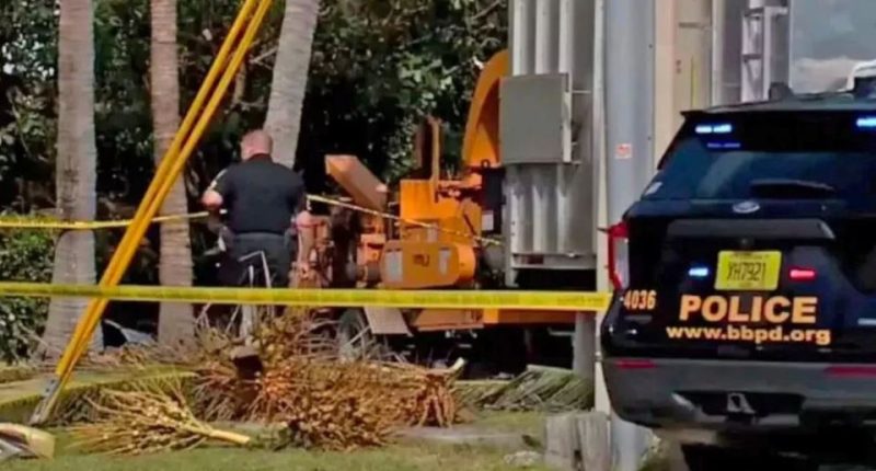 Police at the scene of a fatal wood chipper accident.